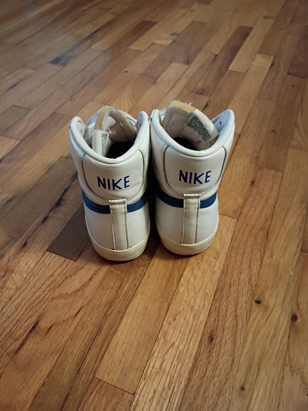 Nike White High-Top Sneakers with Blue Swoosh